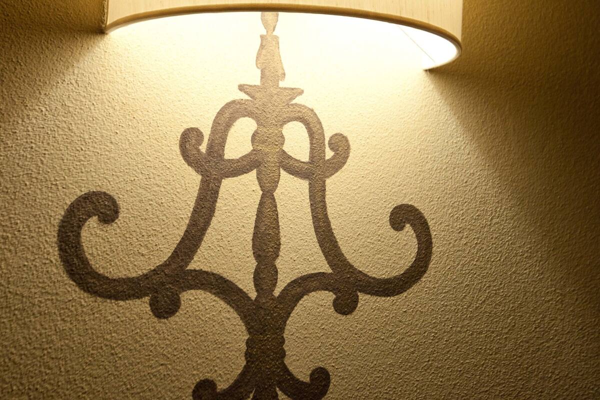 A wall-mounted lamp with a decorative design.