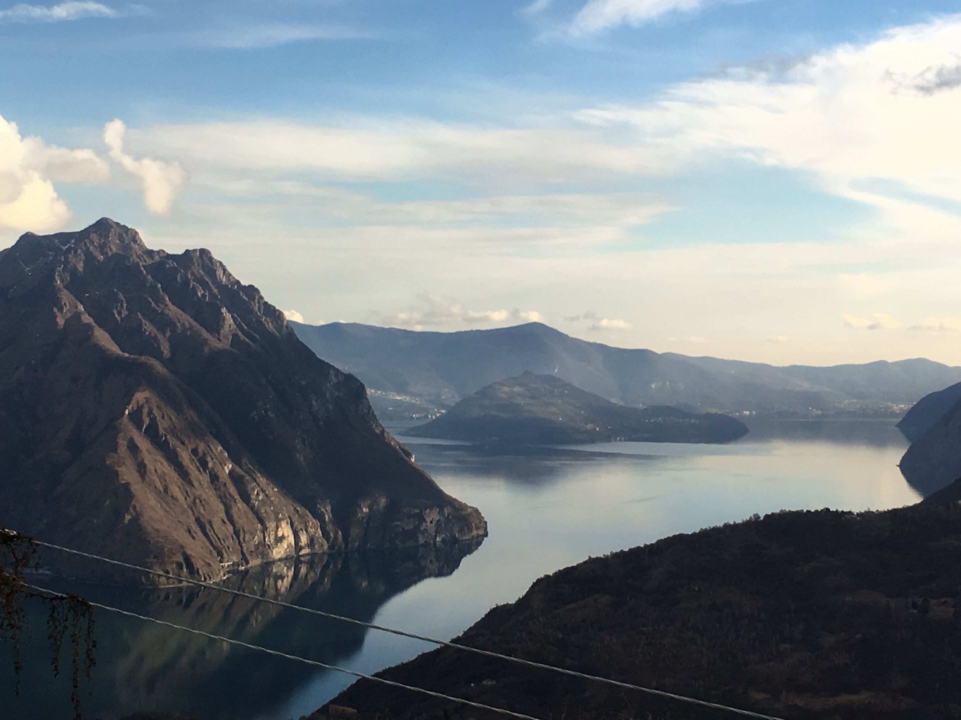 A mountainous landscape with a lake and distant hills.