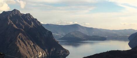 A mountainous landscape with a lake and distant hills.