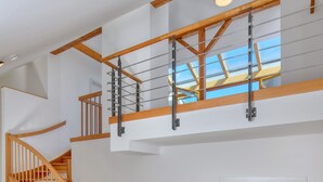A wooden staircase leading to a loft area with a skylight. - DownTown Suites Kodanská (Prague)