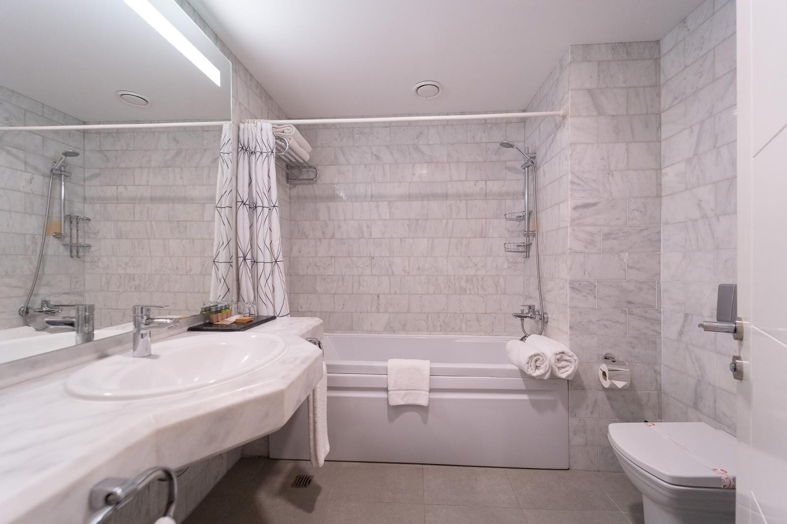 bathtub, free toiletries, hair dryer, slippers