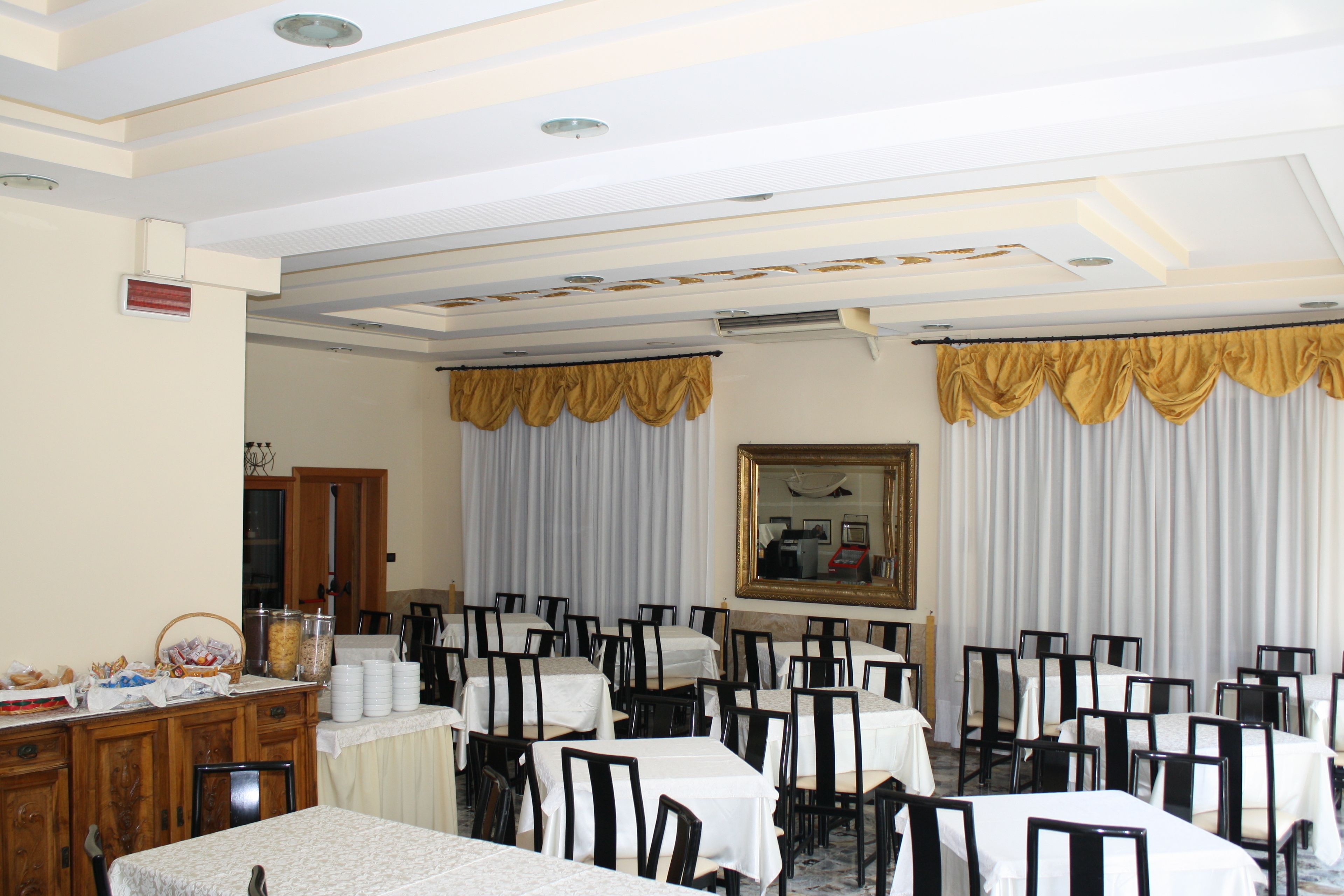 A banquet hall with tables and chairs arranged for a meeting or event.