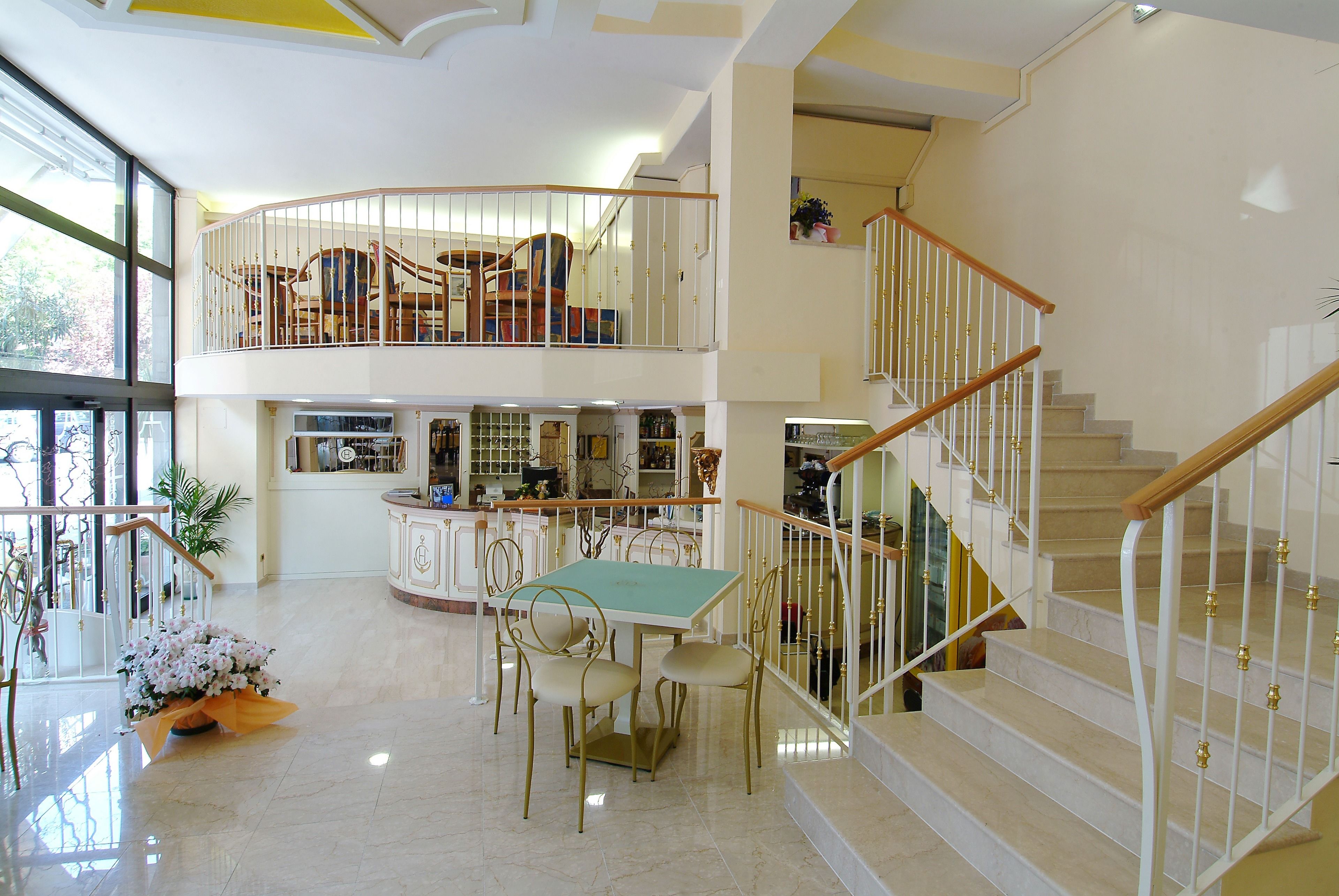 A spacious interior with a dining area, a kitchen, and a staircase.