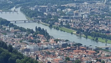 A panoramic view of a city with a river, bridges, and a mix of historical and modern buildings.