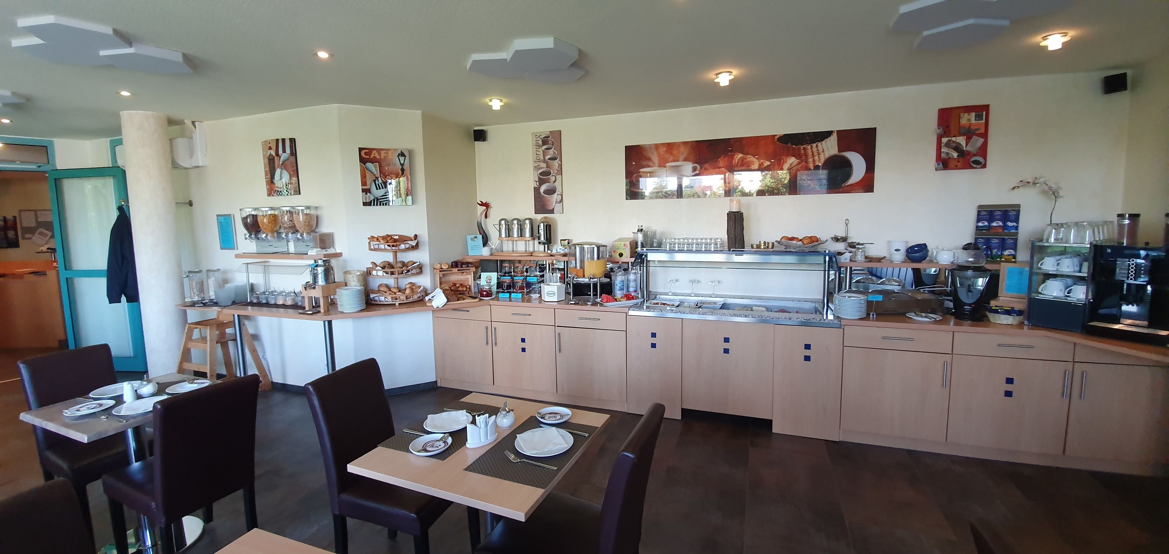 A restaurant with a counter, seating area, and various food and drink items.