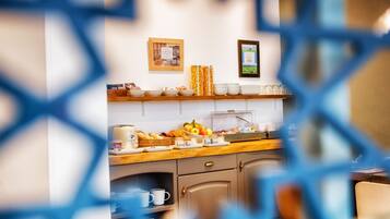 A breakfast buffet with various food items and beverages.