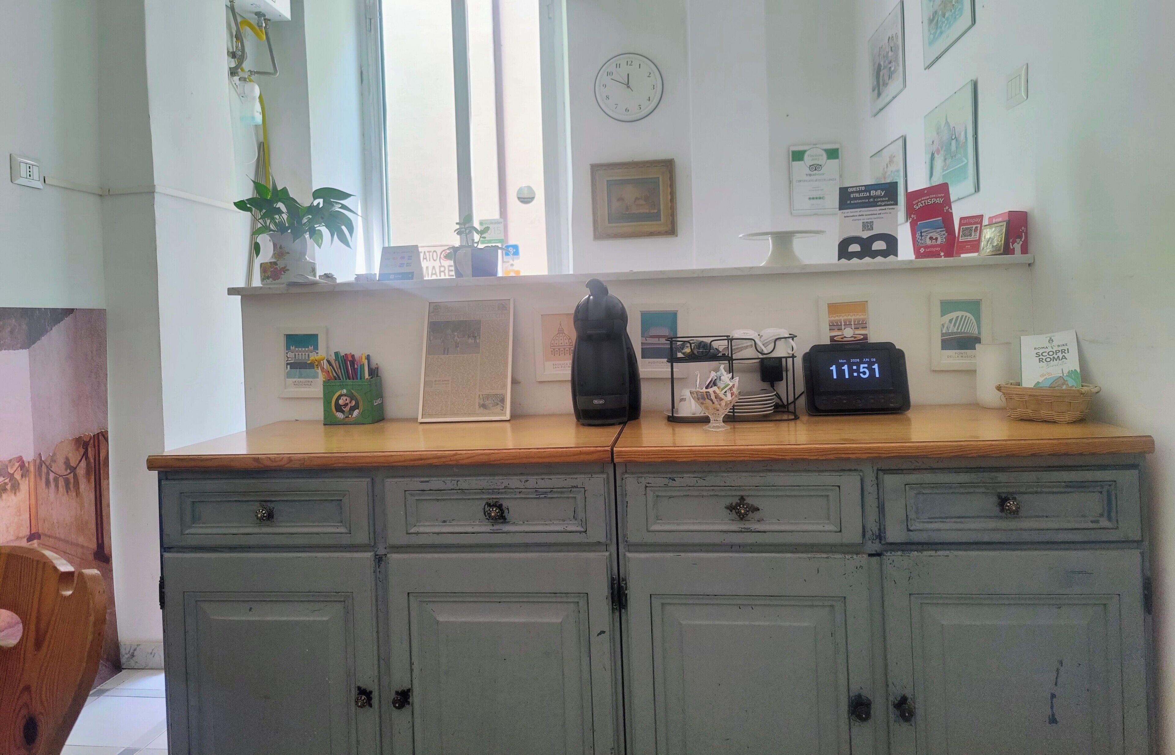 A kitchen with a wooden countertop, a clock, and various kitchen appliances.
