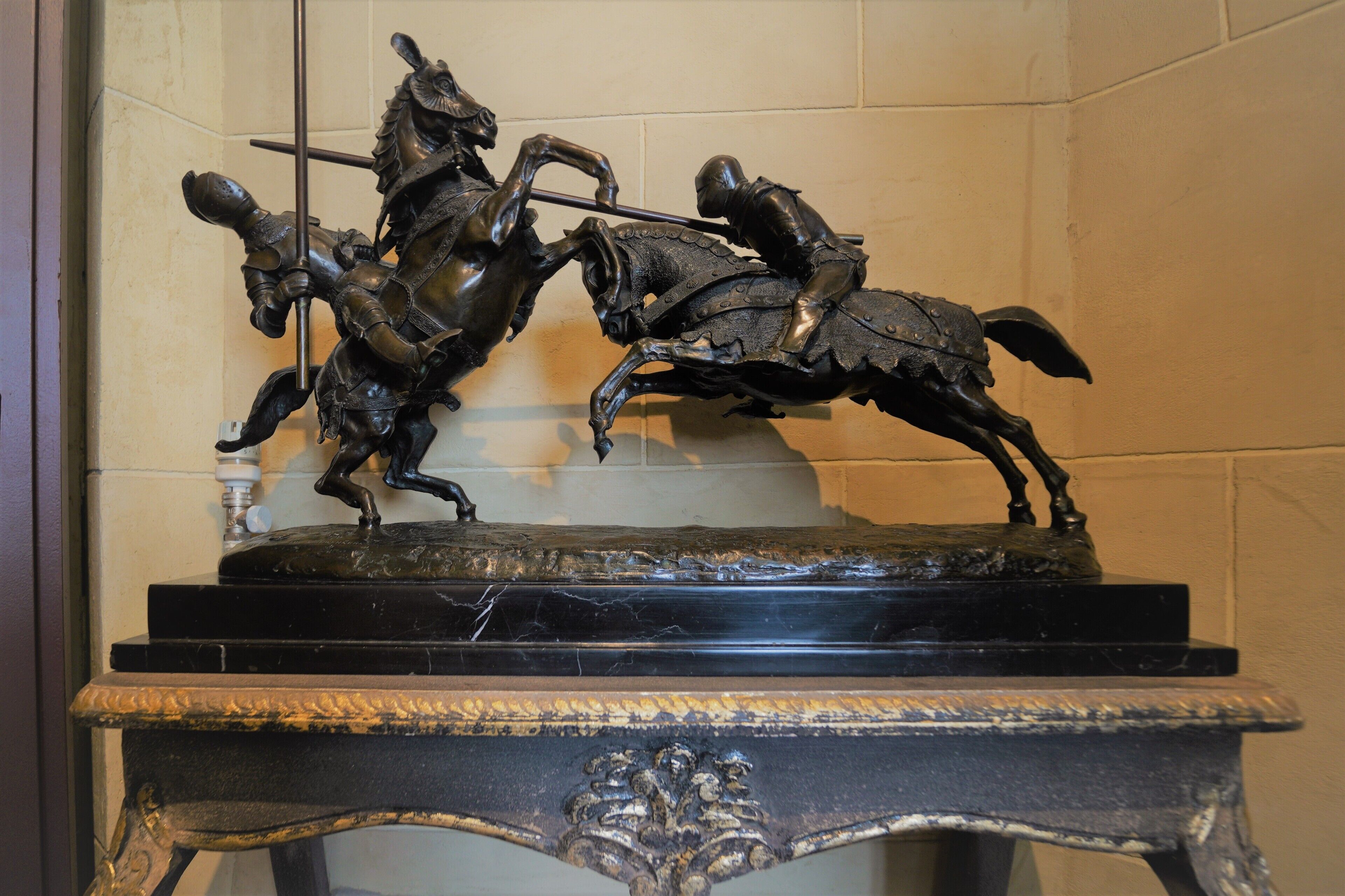 A bronze equestrian statue on a marble pedestal.