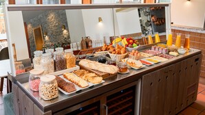 A buffet with various food items and condiments. - Best Western Plus Pays du Mont Blanc (Passy)