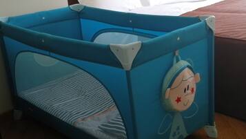 Suitable for families, this room features a baby playpen with a fun design.