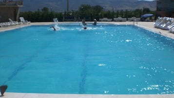 Seasonal outdoor pool, pool umbrellas, pool loungers
