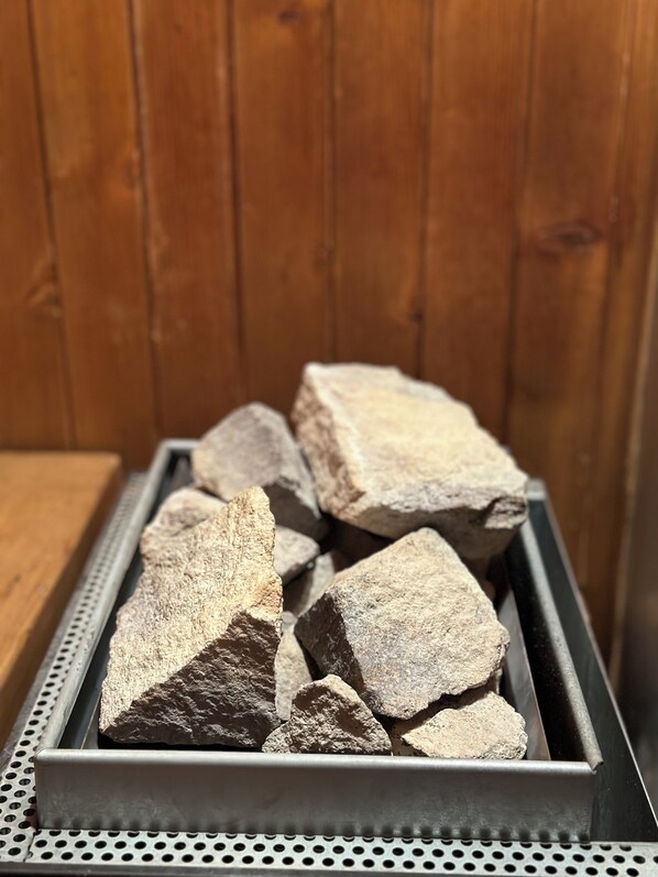 A metal tray filled with variously sized rocks.