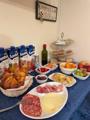 A breakfast buffet with various food items including pastries, fruits, and dairy products. - Casa Famiani Bed & Breakfast (Letojanni)