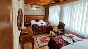 A wooden-paneled bedroom with two beds, a desk, and a chair. - Sirkeci Emek Hotel (Istanbul)