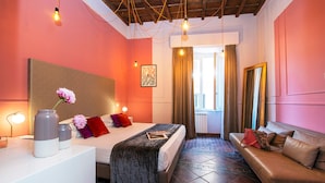 Une chambre d’hôtel avec un lit, un canapé, un bureau et un miroir.