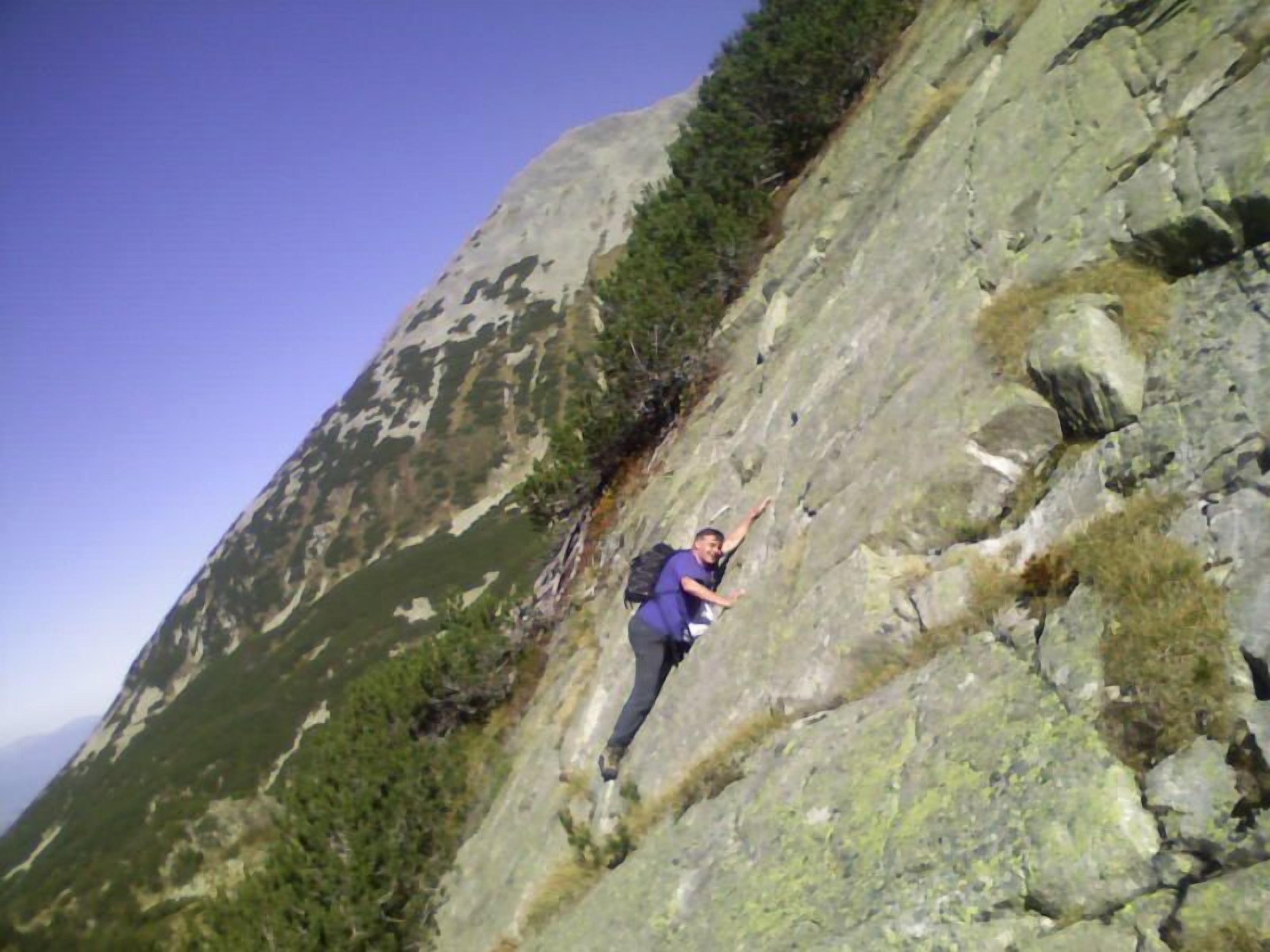 A person climbing a rocky mountain.