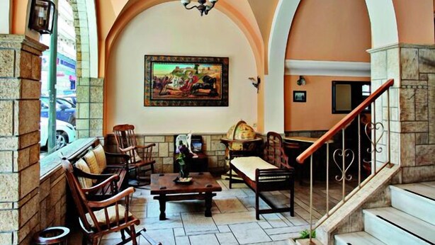 A spacious lobby with arched ceilings, a stone fireplace, and a staircase leading to upper floors. - Boutique Elizabeth Hotel (Athens)