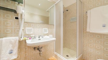 Ein Badezimmer mit Dusche, Waschbecken und Toilette.