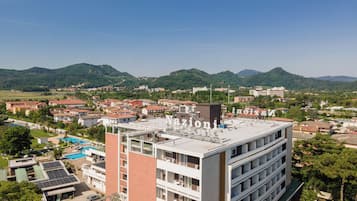 A multi-story hotel with a rooftop pool and solar panels.