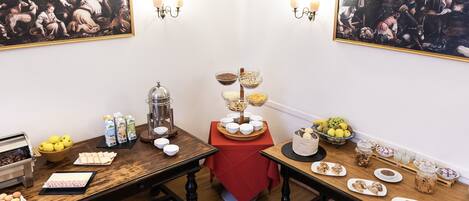 A breakfast buffet setup with various food items and a coffee station.