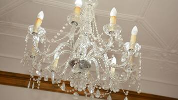 A chandelier with multiple arms and crystal decorations.