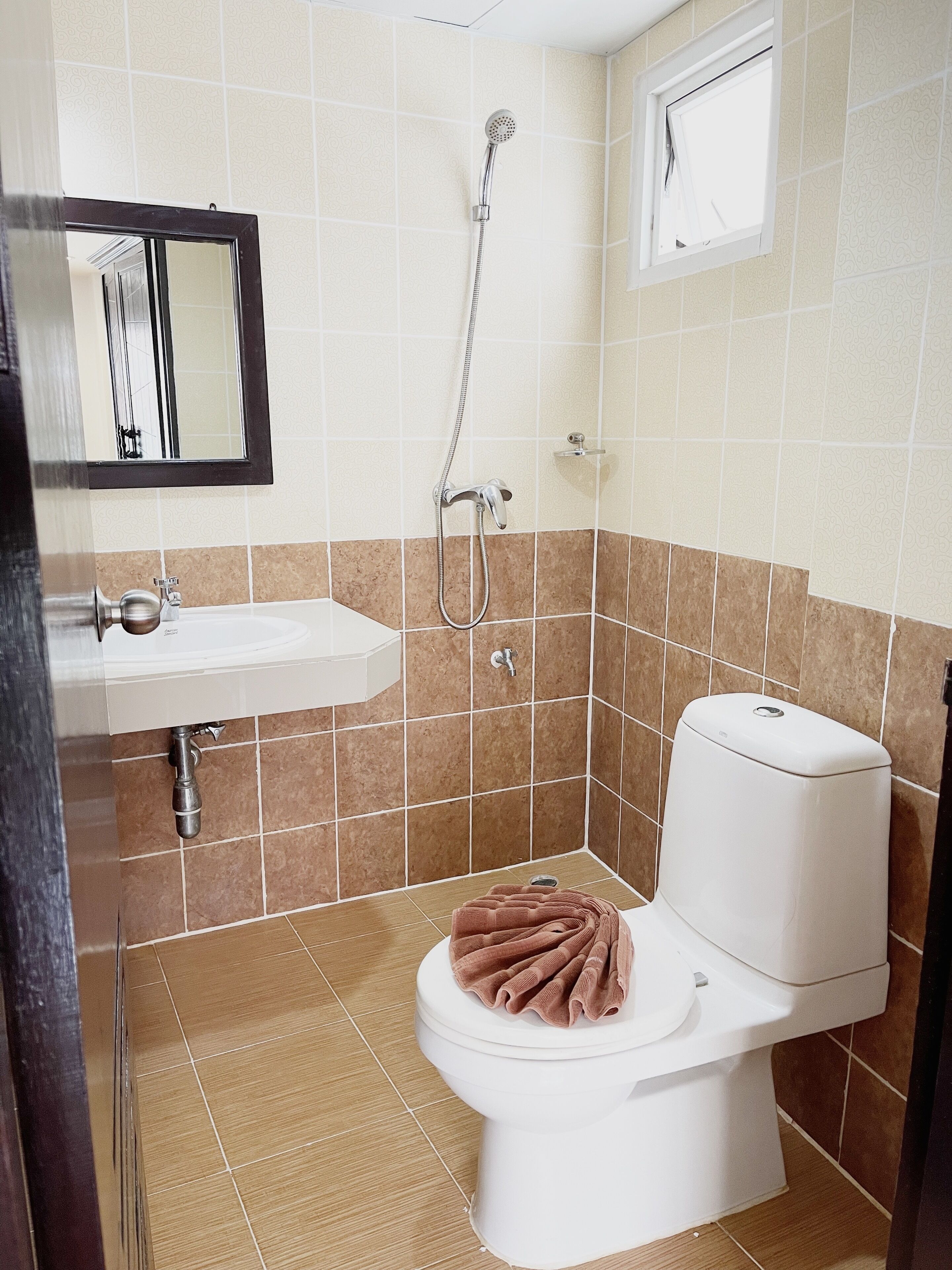 A bathroom with a white sink, a toilet, and a shower.