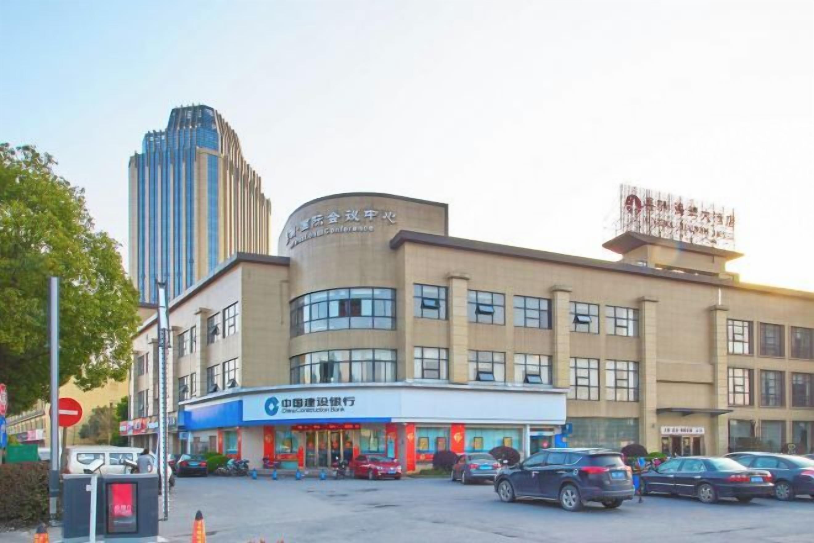A commercial building with a parking lot and several cars.