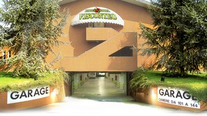 A building with a sign reading "Hotel Motel Visconteo" and a garage entrance. - Hotel Motel Visconteo (Binasco)