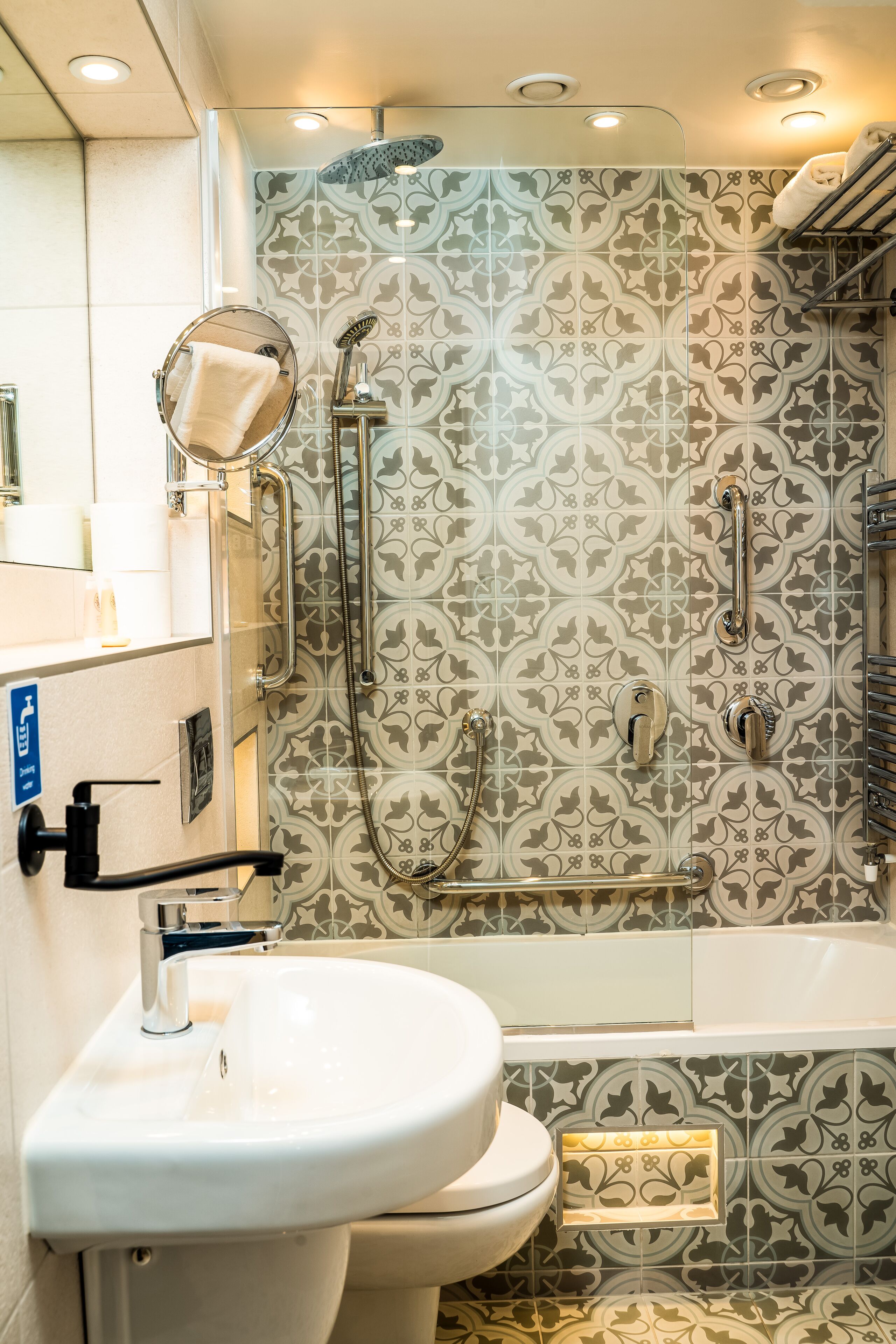 deluxe single room | bathroom | hair dryer, towels