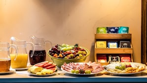 A breakfast buffet with various food items and beverages. - Roxford Lodge Hotel (Dublin)