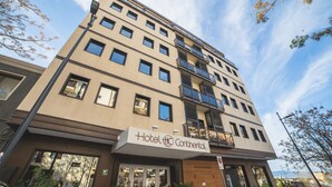 A multi-story hotel with a sign reading "Hotel Continental."