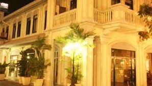 A two-story building with a classical architectural style, featuring a balcony on the second floor. - The Heritage Baan Silom Hotel (Bangkok)