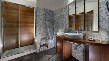 Une salle de bain moderne avec une douche à l’italienne, un meuble-lavabo et un grand miroir.