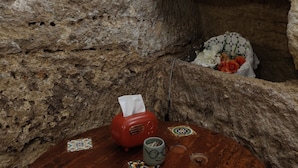 A rustic stone interior with a wooden table, a red radio, and a mug. - B&B Proserpina (Enna)
