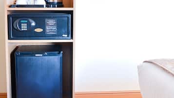 A compact minibar with a coffee maker and a small refrigerator.
