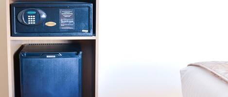 A compact minibar with a coffee maker and a small refrigerator.