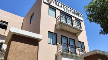 A building with a sign reading "Villa del Carmen".