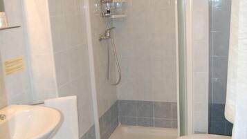 Ein Badezimmer mit Dusche, Waschbecken und Toilette.