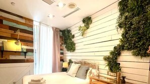A modern bedroom with a bed, bedside table, and a wall-mounted plant. - Hotel Life Gran Via (Madrid)
