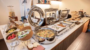 A buffet with various food items, including salads, meats, and desserts. - ibis budget Singapore Imperial (Singapore)