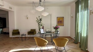 A dining area with a table, chairs, and a laptop.
