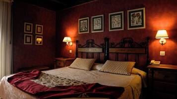 A bedroom with a large bed, two bedside tables, a nightstand, and a wall-mounted lamp.