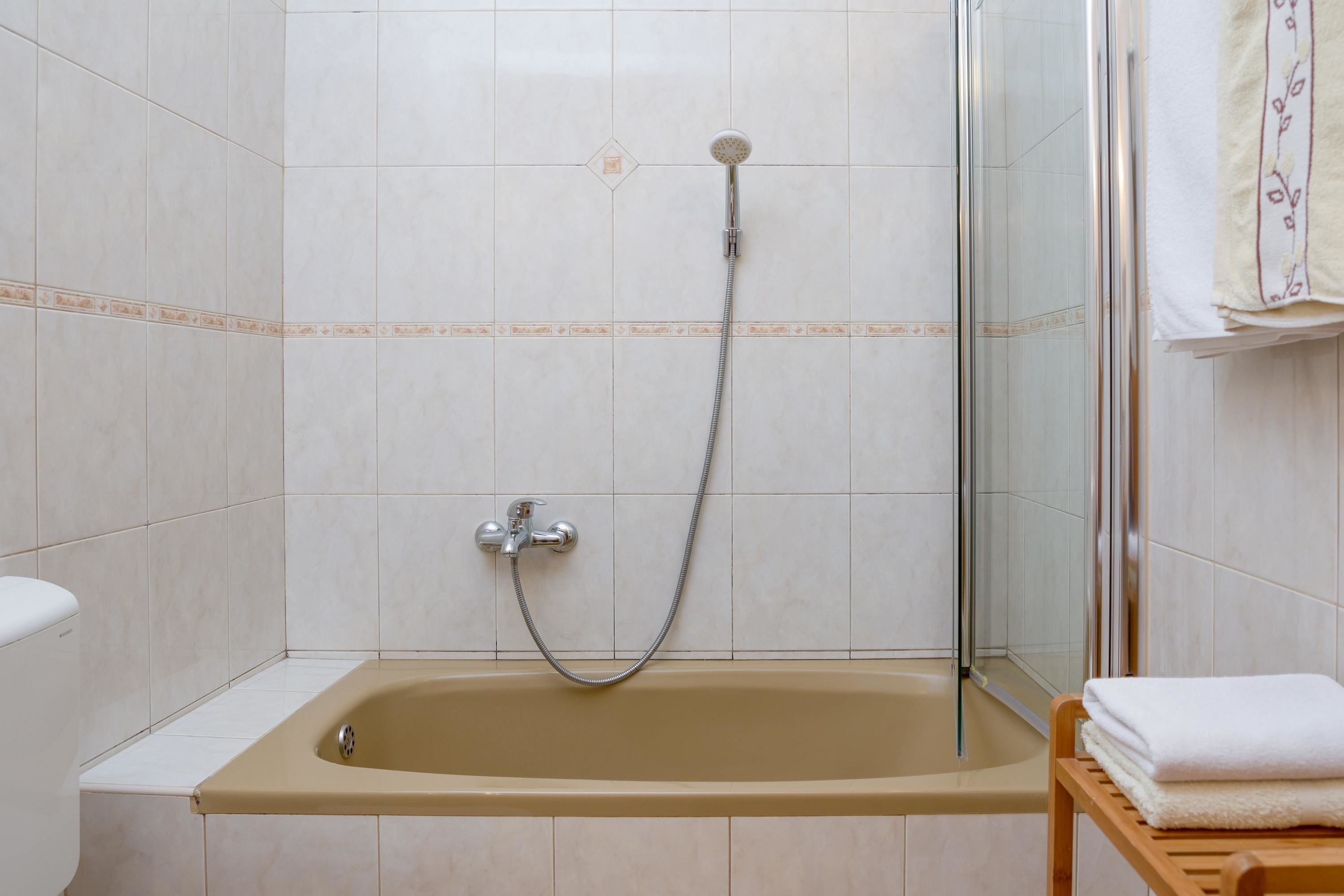 A bathroom with a bathtub, a shower, and a toilet.