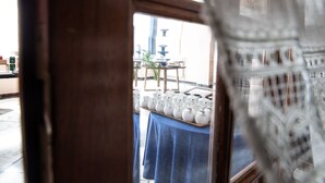 A view through a window with a table displaying white ceramic vases. - Hotel Ariston (Imperia)