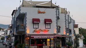 A building with a sign for 'Rebeka Bistro & Cafe' and 'Rebeka Hotel' on the facade. - Rebetika Hotel (Selçuk)