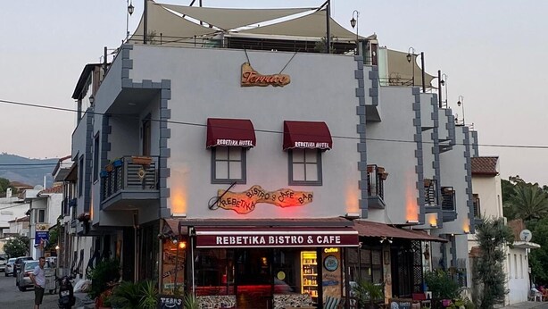 A building with a sign for 'Rebeka Bistro & Cafe' and 'Rebeka Hotel' on the facade. - Rebetika Hotel (Selçuk)