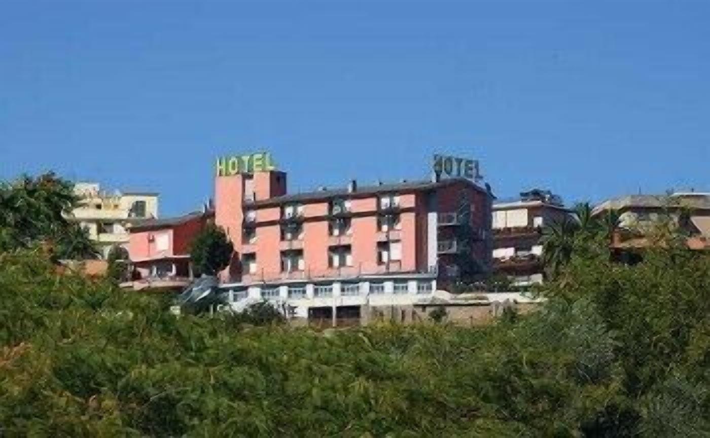A multi-story hotel with a prominent 'HOTEL' sign on the roof.
