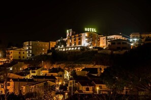 A hotel with multiple stories, a prominent 'HOTEL' sign, and a staircase leading to the entrance. - Tarconte (Tarquinia)