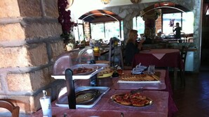 A buffet table with various food items and condiments. - Agriturismo Agave (Alghero)