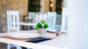 A table set for dining with a QR code sign, a glass, a plate, and cutlery. - La Torre (Tarifa)